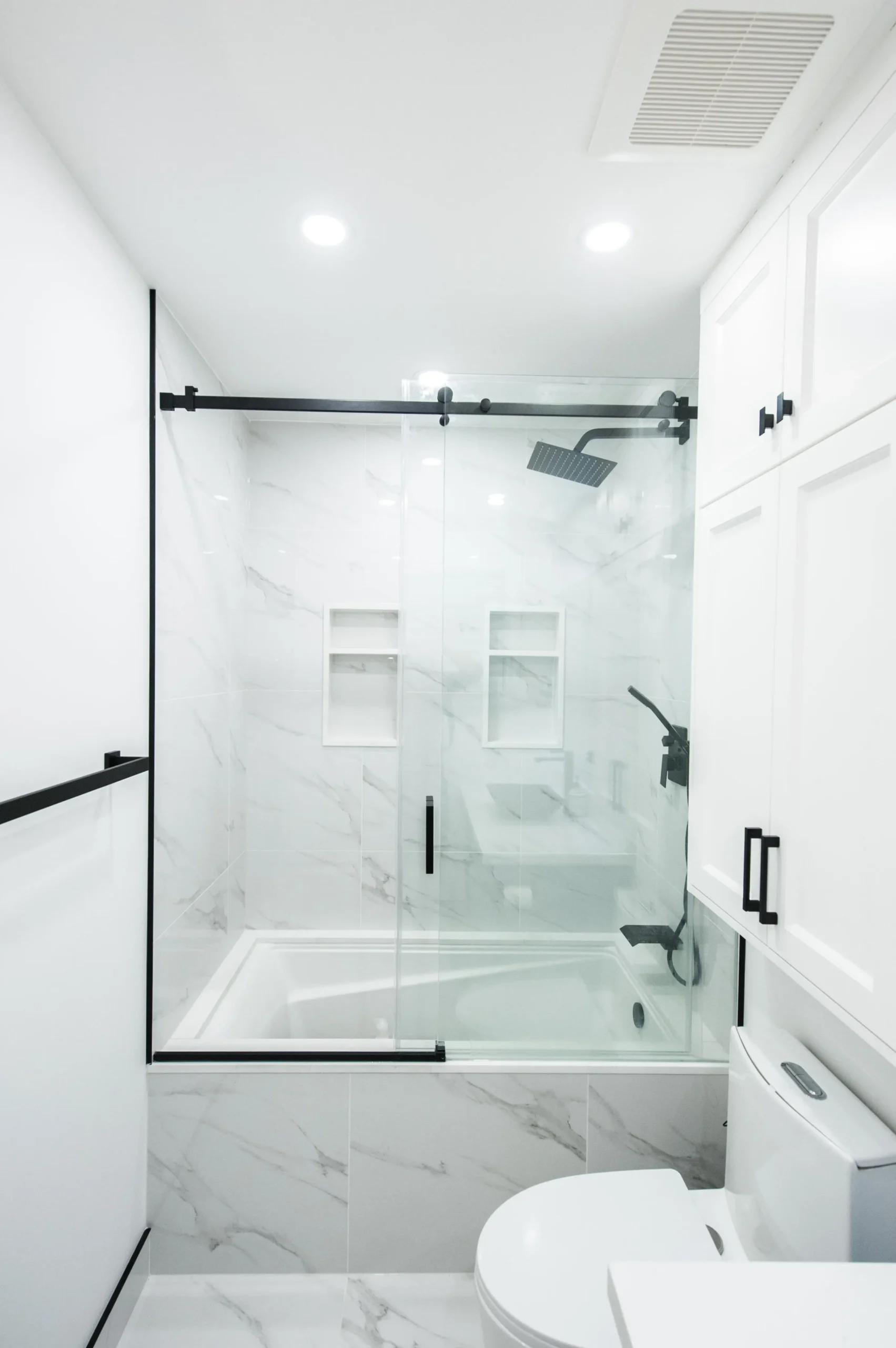 Modern bathroom remodel with spa-style tile and frameless glass shower in a San Francisco home